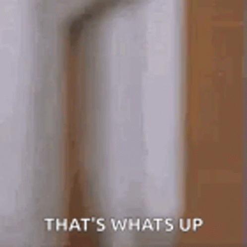 A Man Is Peeking Out From Behind A Door And Says `` That 'S Whats Up '' . GIF