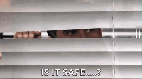 A Man Is Peeking Through The Blinds Of A Window And Asking If It Is Safe . GIF