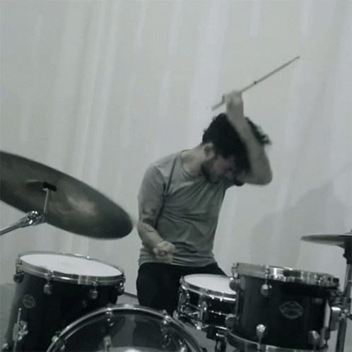 A Man Is Playing A Drum Set With A Cymbal That Says Sabian GIF