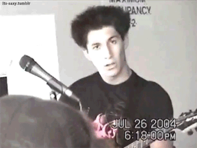 Man Playing Guitar And Singing Into Microphone GIF
