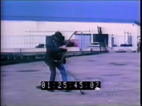 A Man Is Playing A Guitar In A Parking Lot With A Timer That Says 01:25:02 GIF