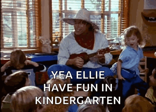 A Man Is Playing A Guitar In Front Of A Group Of Children With The Caption Yea Ellie Have Fun In Kindergarten Written Be GIF