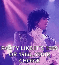 A Man Is Playing A Guitar On A Stage . GIF