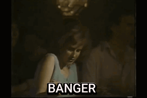 A Man Is Playing A Guitar On Stage In A Black And White Photo With The Word Banger . GIF