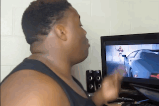 A Man Is Playing A Video Game On A Computer . GIF