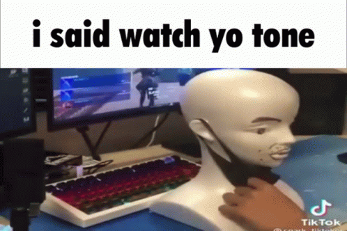 A Man Is Playing A Video Game With A Mannequin Head In Front Of A Computer Monitor And Keyboard GIF