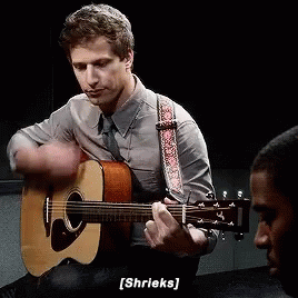 Man Playing Acoustic Guitar And Shriek Sound GIF