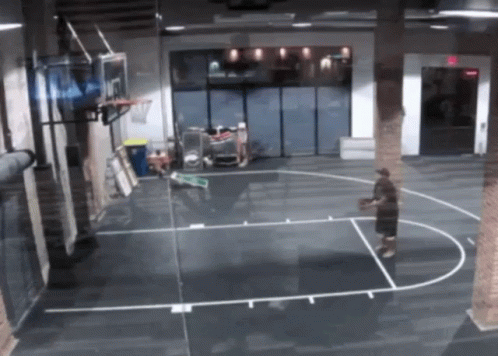 A Man Is Playing Basketball On A Court With A Basketball Hoop That Has The Number 7 On It GIF