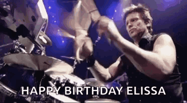 A Man Is Playing Drums On A Stage With The Words `` Happy Birthday Elissa '' Written On It . GIF