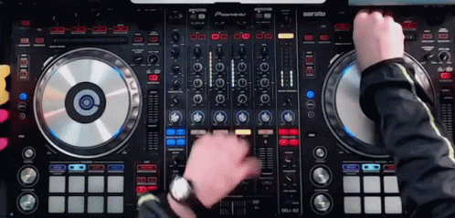 A Man Is Playing Music On A Pioneer Dj Controller GIF