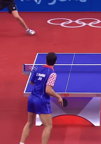 A Man Is Playing Ping Pong And Has The Number 5 On His Shirt GIF