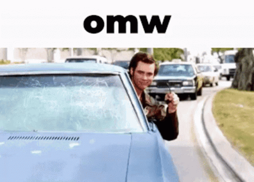 A Man Is Pointing A Gun Out Of The Window Of A Car With The Word Omw Below Him GIF