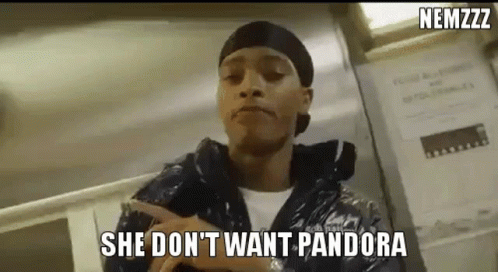A Man Is Pointing At A Sign That Says `` She Don T Want Pandora '' . GIF