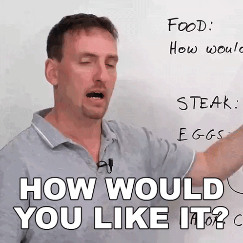 A Man Is Pointing At A White Board With The Words " How Would You Like It " On It GIF
