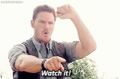 A Man Is Pointing At His Watch And Says `` Watch It '' . GIF