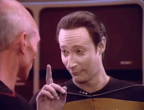 A Man Is Pointing His Finger At Another Man In A Black Shirt GIF