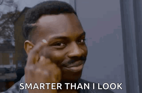 a man is pointing his finger at his forehead and saying smarter than i look