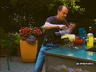 A Man Is Pouring A Drink From A Mixer On A Msnbc Table GIF