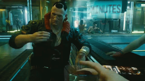 A Man Is Pouring A Drink In Front Of A Sign That Reads Minutes GIF