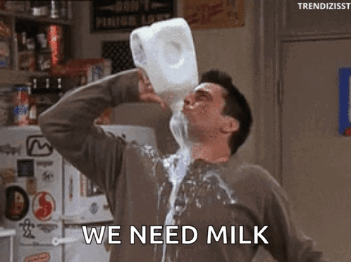 A Man Is Pouring Milk From A Gallon Into His Mouth . GIF