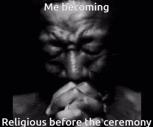 A Man Is Praying In A Black And White Photo . GIF