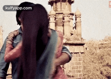 A Man Is Putting His Arm Around A Woman 'S Shoulder . GIF