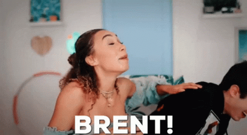 A Man Is Putting His Hand On A Woman 'S Back With The Words Brent Written On The Bottom GIF