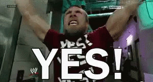 a man is raising his arms in the air and says yes !