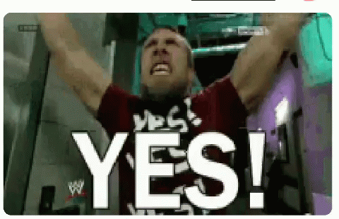 a man is raising his arms in the air and says yes !