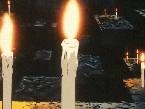 A Man Is Reading A Book With A Cross On His Forehead GIF