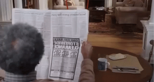 A Man Is Reading A Newspaper With A Headline That Says 30 GIF