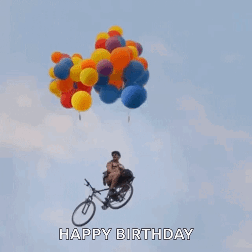 A Man Is Riding A Bike With Balloons Hanging From It In The Air . GIF