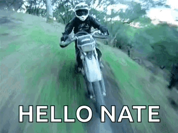 A Man Is Riding A Dirt Bike Down A Dirt Road And The Words `` Hello Nate '' Are Visible . GIF