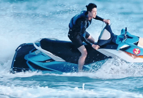 A Man Is Riding A Jet Ski In The Ocean With A Sticker On The Back That Says ' Jet Ski ' GIF