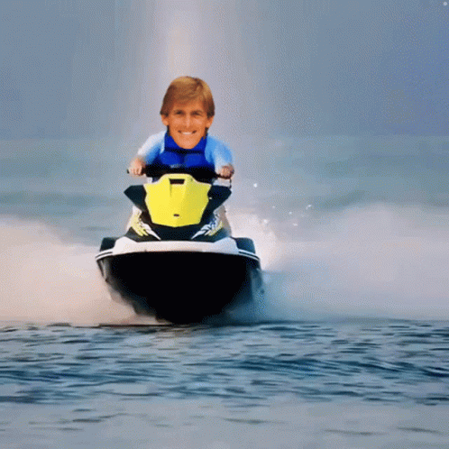 A Man Is Riding A Jet Ski In The Water GIF
