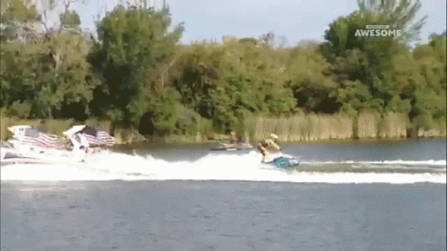 A Man Is Riding A Jet Ski On A Lake And The Words Awesome Are On The Bottom Of The Screen GIF