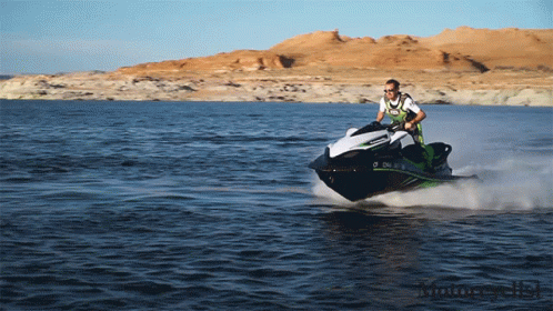 A Man Is Riding A Jet Ski On A Lake With Mountains In The Background And A License Plate That Says O Chl GIF