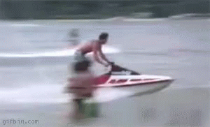 A Man Is Riding A Jet Ski On The Water . GIF