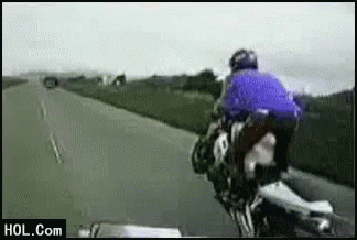 A Man Is Riding A Motorcycle On A Highway And The Website Hol.com Is Visible In The Corner GIF