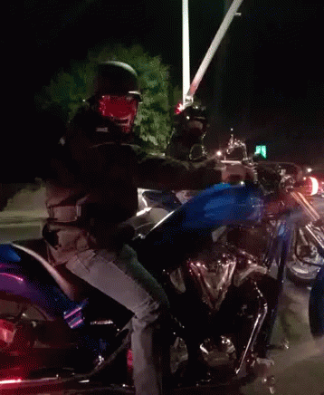 A Man Is Riding A Motorcycle With A Blue Tank GIF