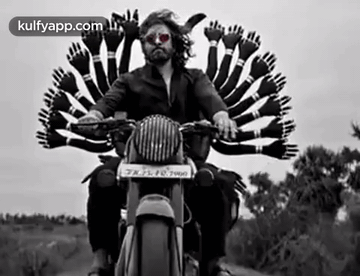 A Man Is Riding A Motorcycle With A Bunch Of Hands On The Back . GIF
