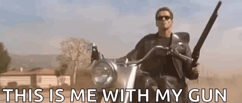 A Man Is Riding A Motorcycle With A Gun In His Hand And The Words `` This Is Me With My Gun '' . GIF