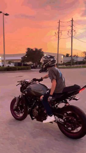 A Man Is Riding A Motorcycle With A Helmet On GIF