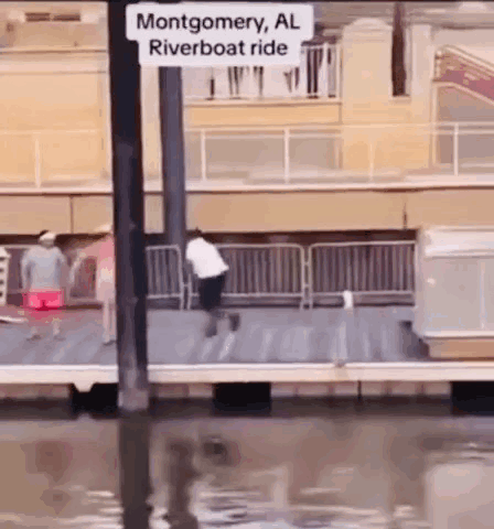 A Man Is Riding A Riverboat In Montgomery Al . GIF