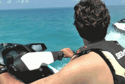 A Man Is Riding A Sea Doo Jet Ski In The Water GIF
