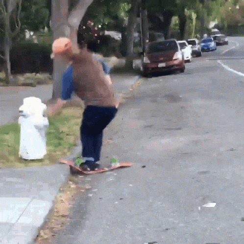 A Man Is Riding A Skateboard On The Side Of The Road GIF