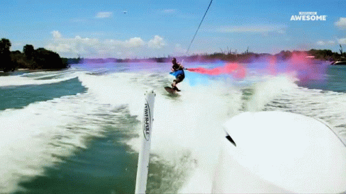 A Man Is Riding A Surfboard In The Water And The Words Awesome Are On The Bottom GIF