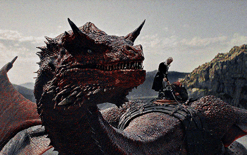 A Man Is Riding On The Back Of A Dragon GIF