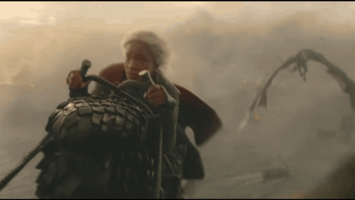 a man is riding on the back of a giant monster
