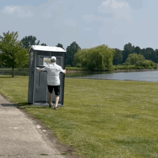 A Man Is Running Away From A Portable Toilet That Has A Sign On The Door That Says ' Emergency Exit ' GIF